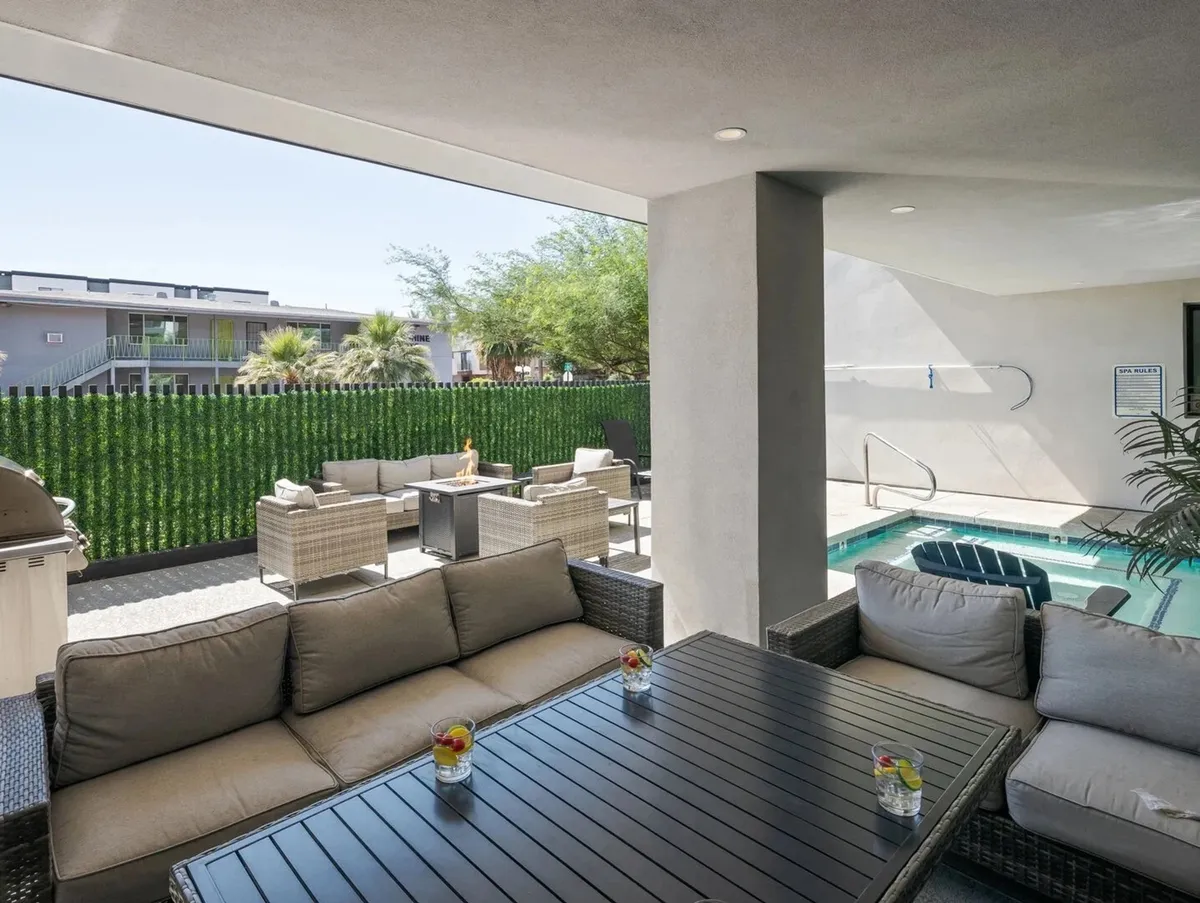 A welcoming outdoor amenity area with a sofa seating arrangement, sparkling swimming pool, and outdoor dining table. The setting is ideal for relaxing, socializing, or hosting a barbecue with friends—activities that echo the section’s focus on group enjoyment and relaxation after an evening out.