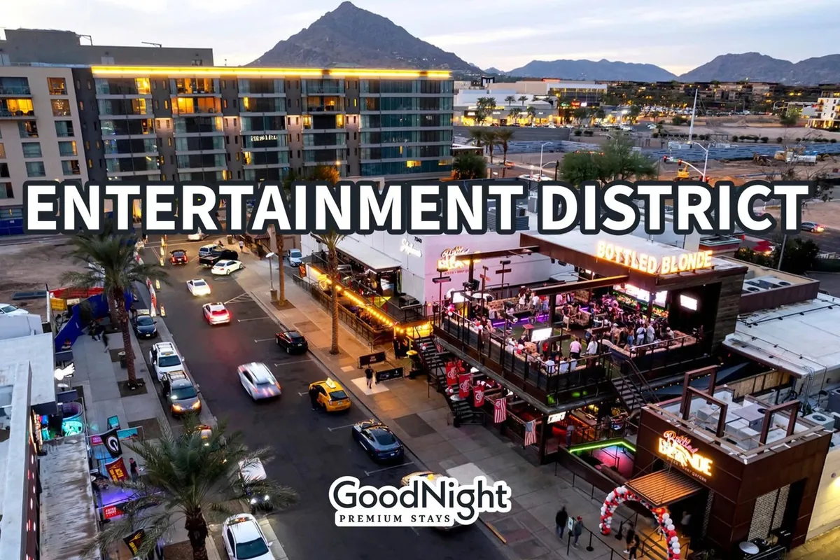 This image captures a lively streetscape with entertainment venues, cars on the street, and a scenic mountain backdrop. The energy is palpable, reflecting the vibrant nightlife and social possibilities just outside the property. The combination of urban lighting, bustling activity, and the inviting mountain view creates an atmosphere perfect for an evening out in Old Town Scottsdale.